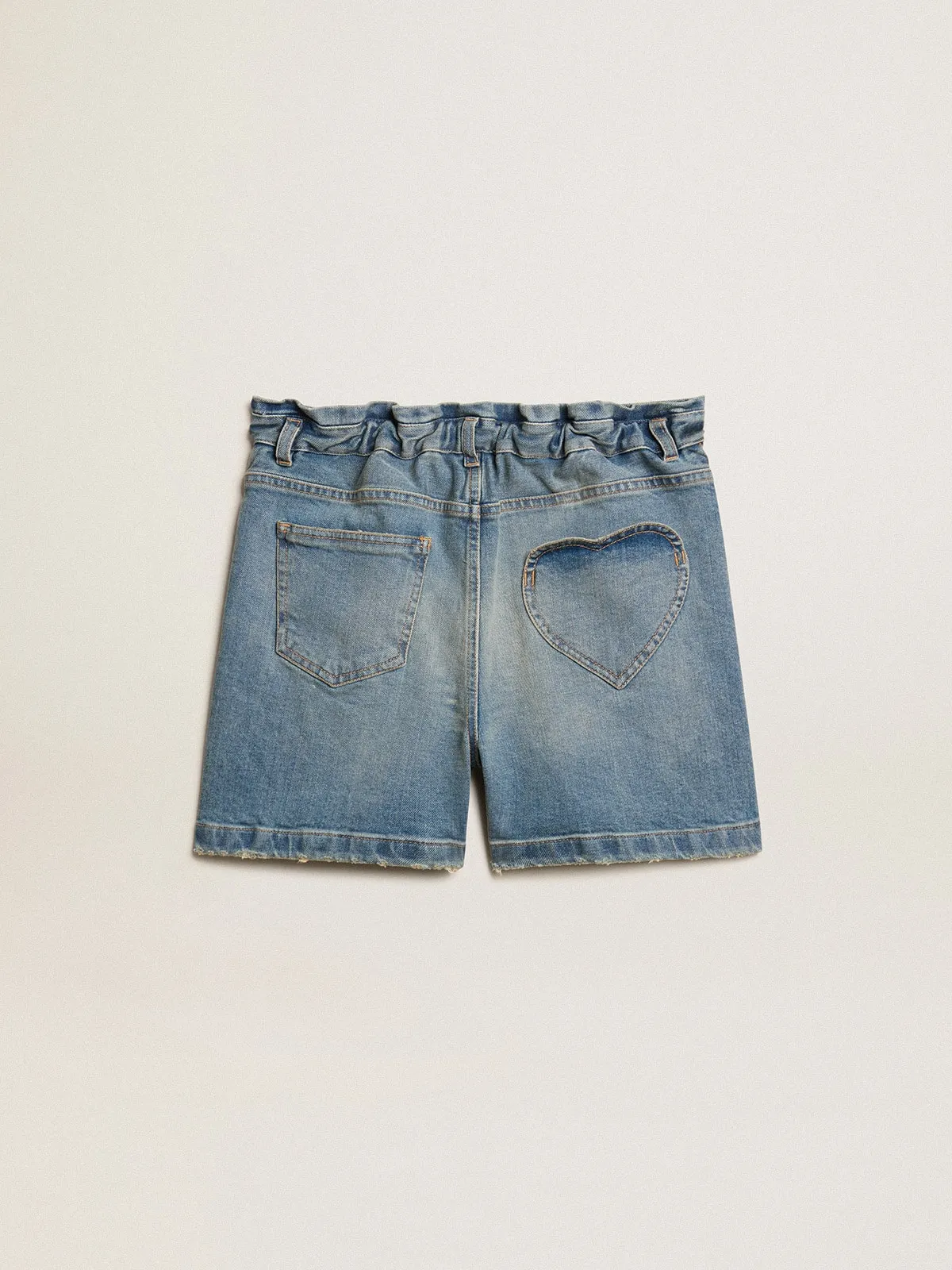 Pantalón corto en tejido vaquero de niña de efecto desgastado